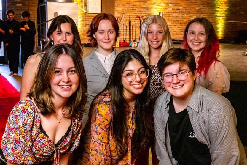 A group of seven students smiles